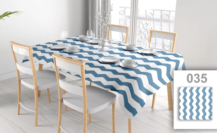 Custom size stain-resistant tablecloth with blue and white chevron pattern on a set dining table with chairs