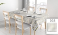 Stain-resistant rectangular tablecloth with a colorful geometric leaf pattern in a modern dining setting.
