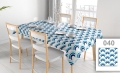 Custom printed waterproof tablecloth with blue wave pattern on a dining table with chairs and place settings