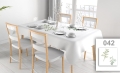 Custom printed stain-resistant tablecloth with a botanical leaf design on a set dining table with chairs