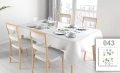 Stain-resistant rectangular tablecloth with custom watercolor floral print on a set dining table with chairs