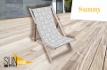 Wooden deck chair with a grey and white circle pattern on a light wood deck with Sunny and Sunshade logos.
