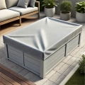 Grey custom cover protects a rectangular garden coffee table on a patio next to an outdoor sofa and potted plants