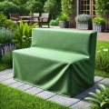 Custom-made green protective cover for garden furniture on a stone patio in a lush backyard garden environment