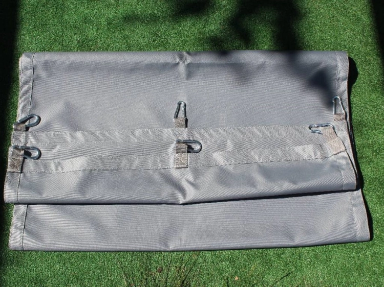 Grey waterproof pergola shade sail 0.5x5m with metal snap hooks on a green artificial grass background