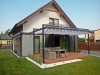 Premium retractable 3x4 m waterproof patio Roman blind provides shade over a modern outdoor lounge set and deck