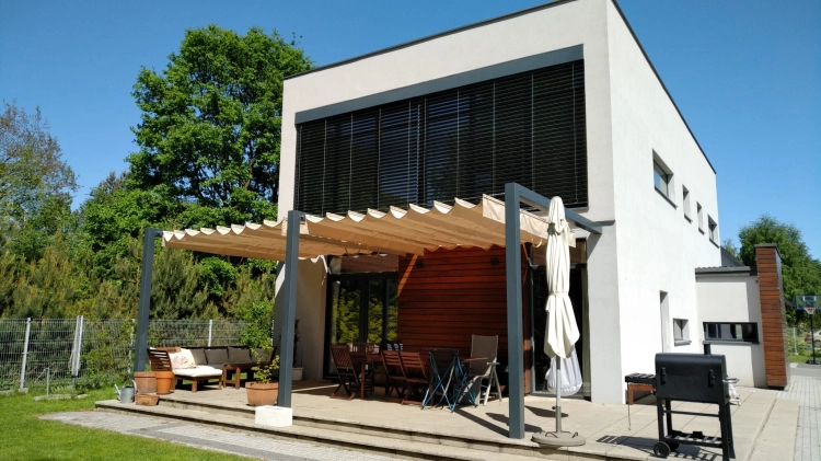 Retractable roman patio canopy 3x4 m provides sun and water protection over a modern house terrace with outdoor furniture