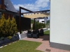 Retractable 3x4m Roman awning for patio shade over outdoor furniture in a modern garden setup