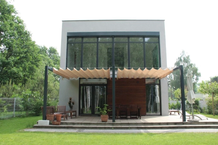 Roman terrace blind 3x4 m in premium waterproof fabric providing sun protection over a modern house patio