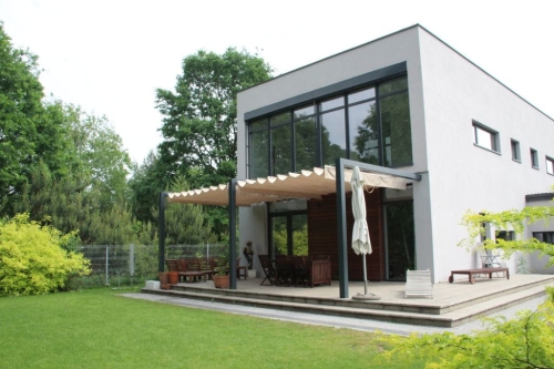 Beige 3x4 m retractable Roman patio awning canopy on a modern house terrace for sun and rain protection
