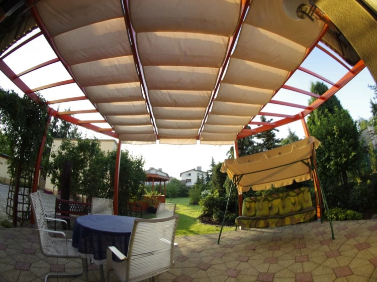 Premium waterproof roman shade for terrace 3x4 m installed over a patio seating area with a table and chairs