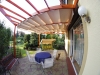 Retractable Roman canopy shade for a 3x4 m wooden patio pergola with outdoor dining set and garden swing