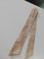 Light beige waterproof garden curtain tie-back with visible stitching on a white background