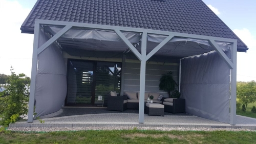Custom-made waterproof gray roman blinds for a modern patio pergola with outdoor lounge furniture